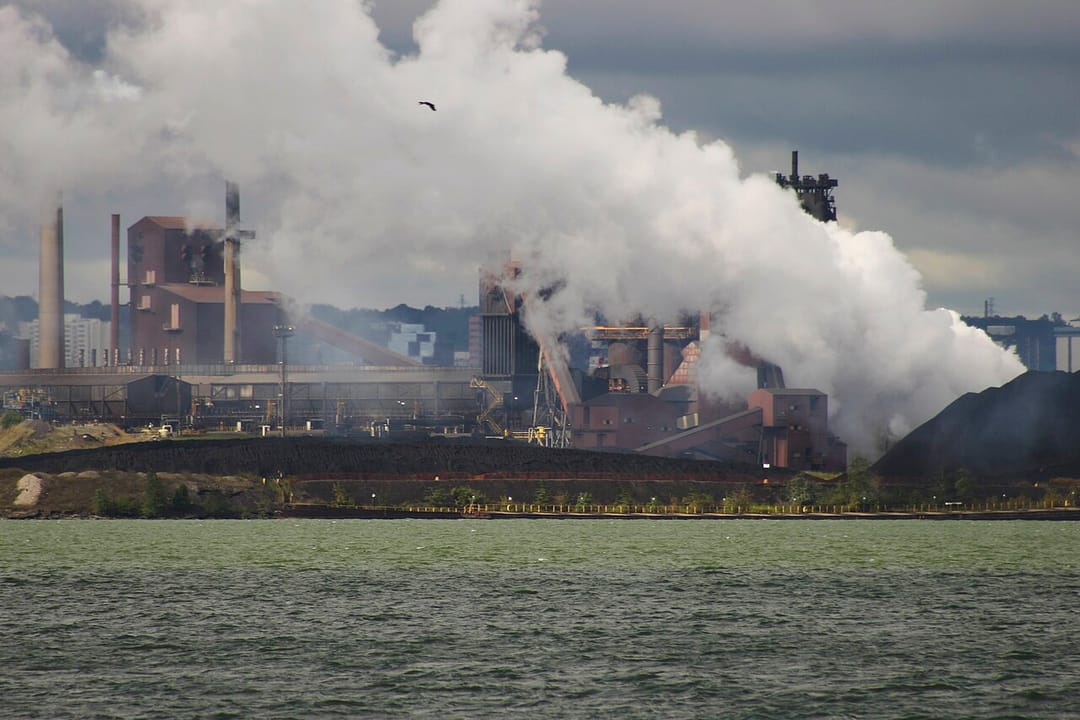 Stelco industrial buildings and white plumes viewed across water in Hamilton in an August 2006 archive photograph.