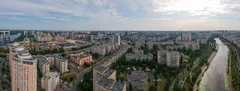 Archive panorama of Kyiv’s Rusanivka district, with apartment buildings, streets and a canal under a cloudy sky.