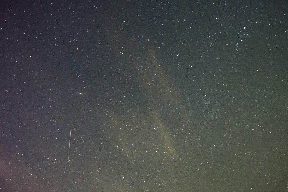 A faint Orionid meteor streak among stars near the Andromeda galaxy in an October 2020 photograph.