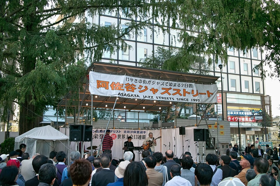 Musicians perform beneath an Asagaya Jazz Streets banner before an outdoor audience in October 2012.