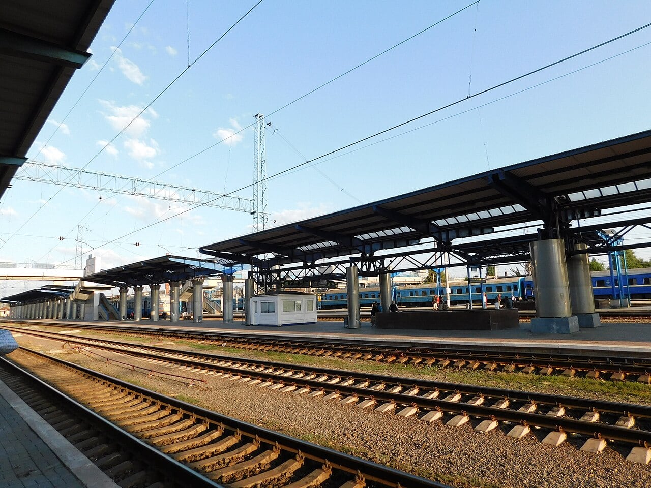 Covered platforms, railway tracks and a blue train at Dnipro station in an August 2019 archive photograph.