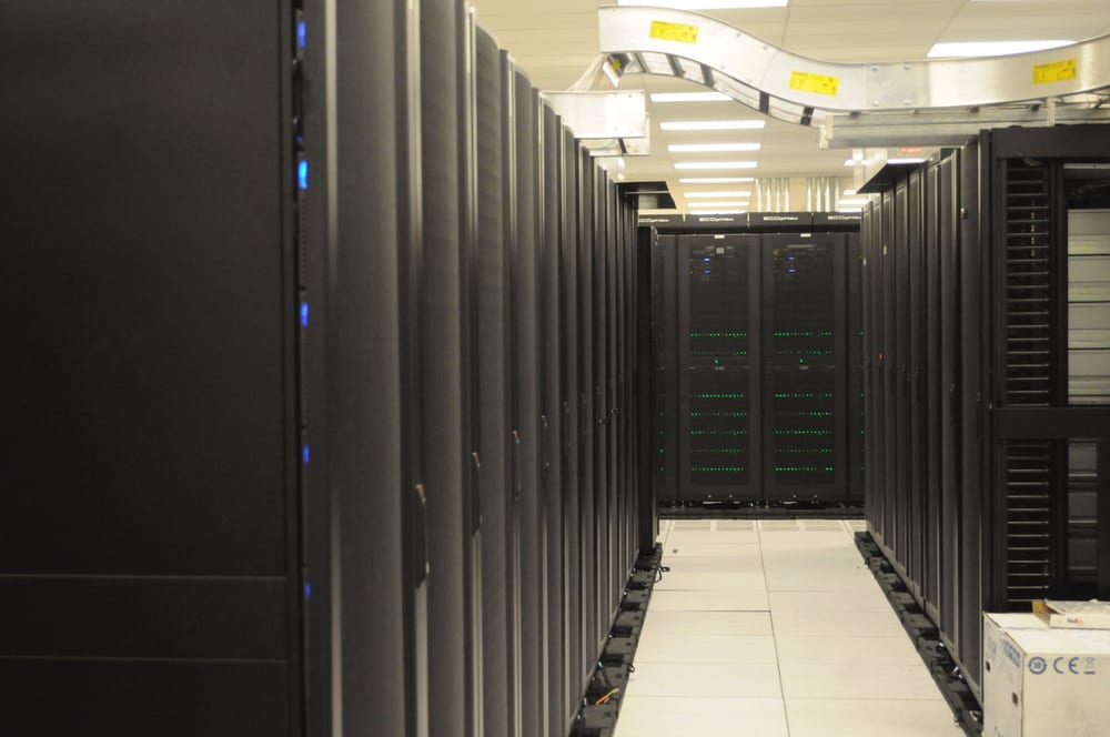 Rows of server racks and overhead cabling at NERSC in an October 2011 photograph.